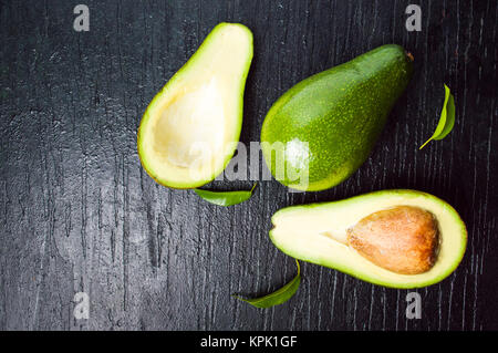 Avocado slices on dark table top view Stock Photo