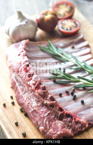 Raw lamb ribs with fresh rosemary Stock Photo