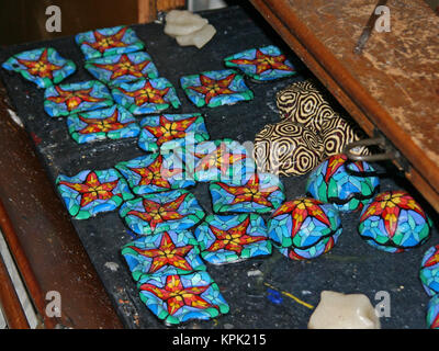 Colourful completed candles drying in display on tray, Kingdom of Swaziland. Stock Photo