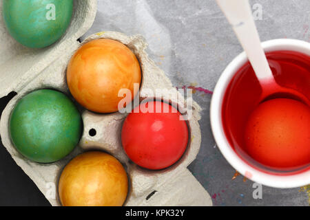 Colored Easter eggs and liquid color dye Stock Photo