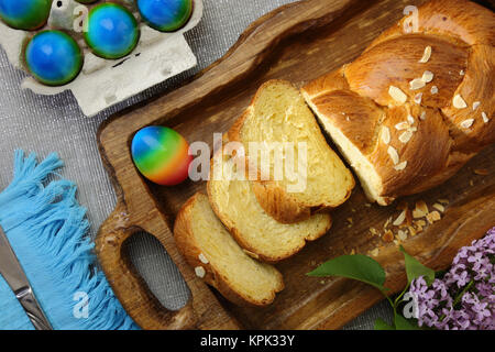 Easter sweet brioche and colored eggs Stock Photo