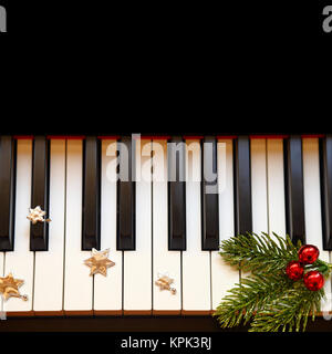 Christmas branch on piano keys Stock Photo