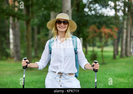 young woman with nordic walk pols Stock Photo