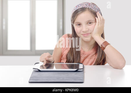 Beautiful pre-teen girl with a tablet computer. Stock Photo