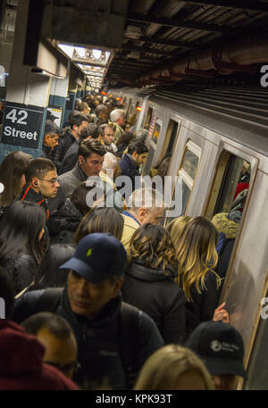 Overly crowded subway train platform during the evening rush hour at the 42nd Street Times Square subway station in midtown Manhattan, New York City. Stock Photo
