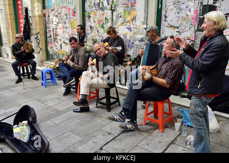 Group of musician buskers playing traditional instruments along pavement in central Athens, Greece Stock Photo