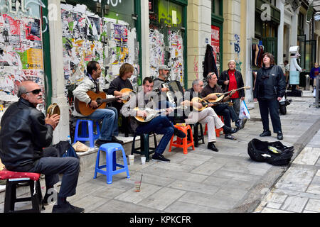 Group of musician buskers playing traditional instruments along pavement in central Athens, Greece Stock Photo