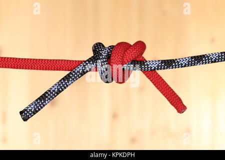 a red and a black string knotted together Stock Photo - Alamy