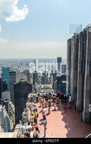 NEW YORK CITY - JULY 12: People look at Manhattan from Rockefeller Center Observation Deck on July 12, 2012 in New York. Manhattan is a major commerci Stock Photo