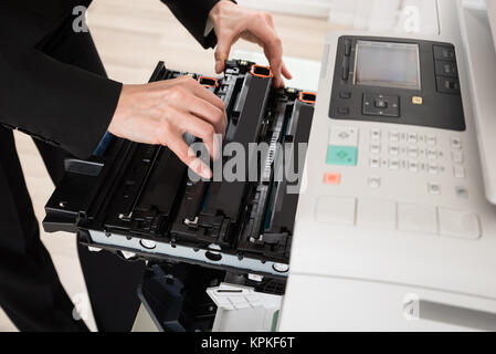 Businesswoman Hand Fixing Copy Machine Stock Photo