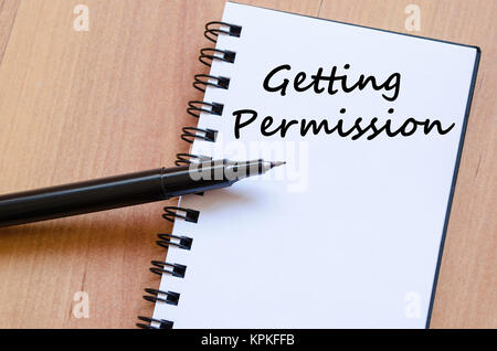 Getting permission write on notebook Stock Photo