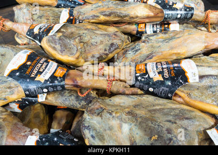 Whole cured Iberian ham piled up in a Spanish supermarket Stock Photo