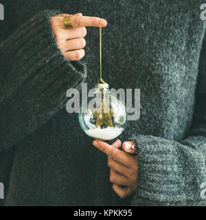 Woman in grey sweater holding decorative glass ball, square crop Stock Photo