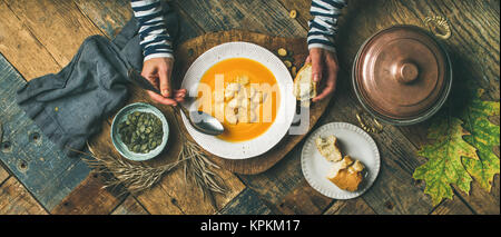 Fall warming pumpkin cream soup, top view, wide composition Stock Photo