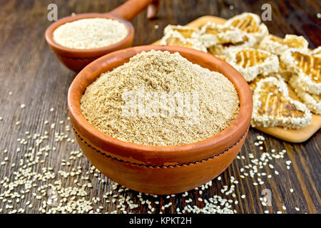 Flour sesame in bowl with cookies on board Stock Photo