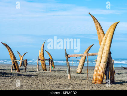 Traditional Peruvian small Reed Boats (Caballitos de Totora), straw boats still used by local fishermens in Peru Stock Photo