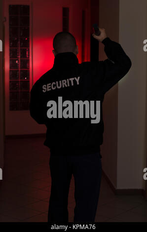 Security man, checks in the dark with flashlight Stock Photo