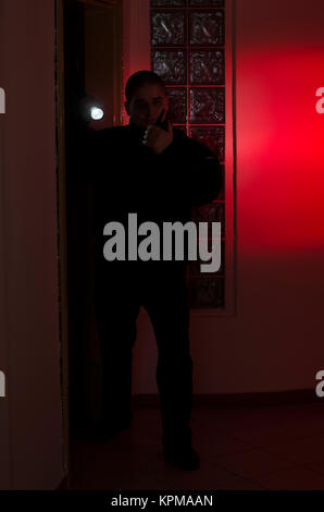 Security man, checks in the dark with flashlight Stock Photo