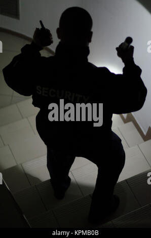 Security man, checks in the dark with flashlight Stock Photo