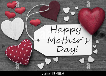 Label With Red Textile Hearts On Wooden Gray Background. English Text Happy Mothers Day. Retro Or Vintage Style. Black And White Image With Colored Hot Spot. Stock Photo