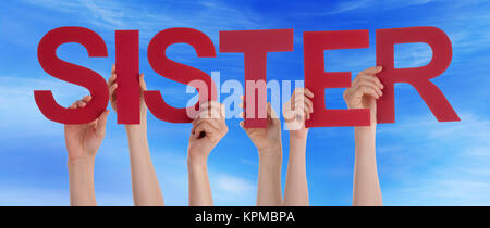 Many Caucasian People And Hands Holding Red Straight Letters Or Characters Building The English Word Sister On Blue Sky Stock Photo
