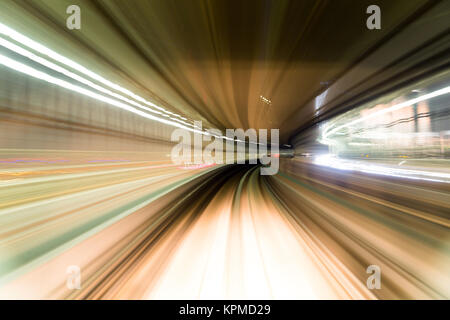 Fast train passing by train station Stock Photo