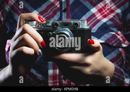 Closeup of retro camera in hipster girl hands Stock Photo