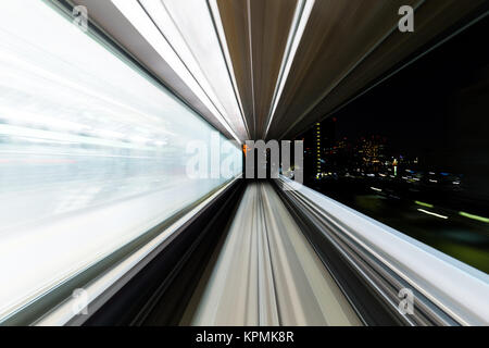 Fast train passing through city Stock Photo