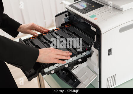 Businesswoman Hand Fixing Copy Machine Stock Photo