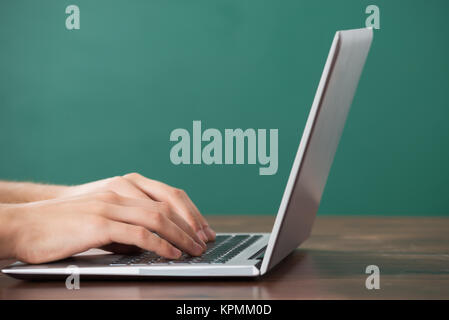Man Working On Computer At Desk Stock Photo