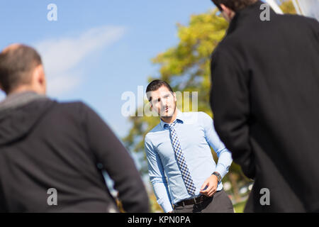 Businessman being blackmailed by two racketeers. Stock Photo