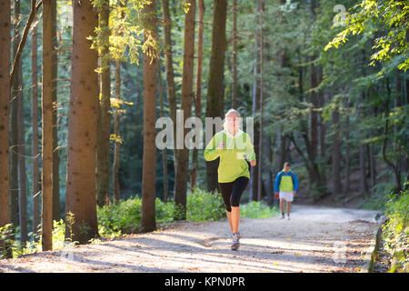 Pretty young girl runner in the forest. Stock Photo