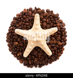 Starfish lie on the circle of coffee beans isolated on white background Stock Photo