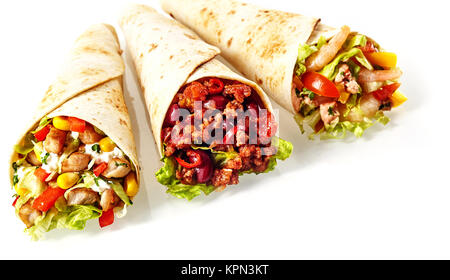 Close Up Still Life of Trio of Tex Mex Fajita Wraps Wrapped in Grilled Flour Tortillas and Filled with Variety of Fillings Such as Chicken, Chili and Shrimp and Fresh Vegetables on White Background Stock Photo