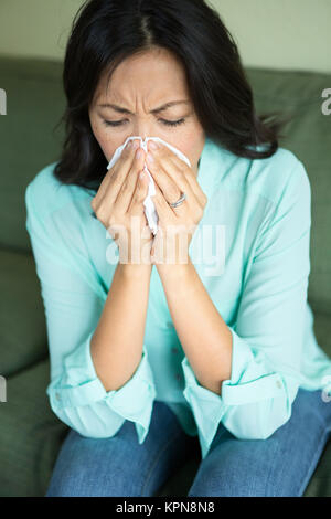 Asian woman blowing her nose. Stock Photo