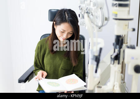 Woman doing the colour test on book Stock Photo