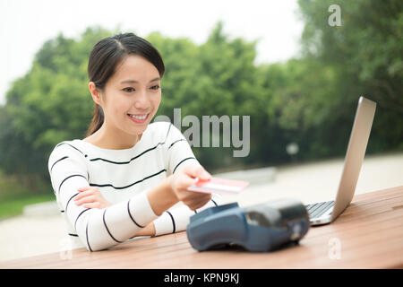 Woman pay by credit on the bill Stock Photo