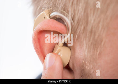 Man Wearing Hearing Aid In Ear Stock Photo