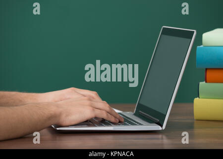 Man Working On Computer At Desk Stock Photo