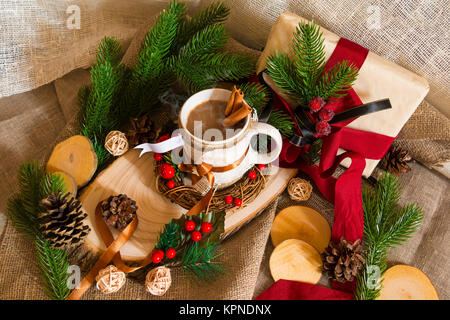 New Year's still life with a cup of coffee, a gift box and pine branches Stock Photo