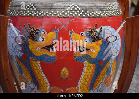 Closeup of a red drum decorated with colorful drawings of chinese dragons in Hong Kong, China Stock Photo