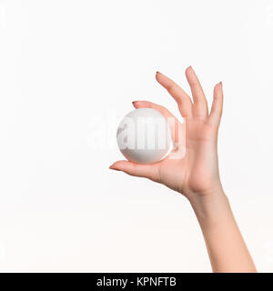 The female hand holding white blank styrofoam ball Stock Photo