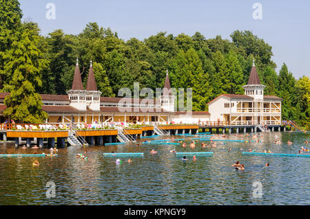 Bathers enjoy an unrivaled experience in the world’s largest natural thermal lake - Heviz, Hungary Stock Photo