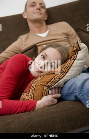 Model release , Junges Paar gemeinsam auf der Couch - young couple on couch Stock Photo