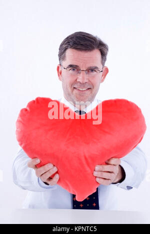 Model release , Attraktiver Mann, 50+, mit Stoffherz - attractive man, with heart Stock Photo