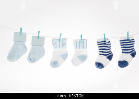 Blue and white baby socks on clothesline, isolated Stock Photo