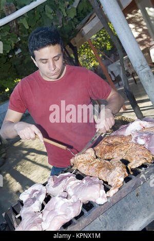 Model release , Mann beim Grillen - barbecue Stock Photo