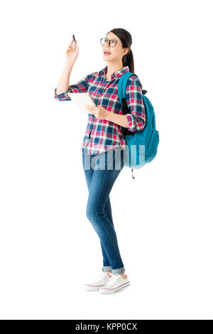 beauty attractive college girl holding notebook daydreaming and having good idea isolated on white background. Stock Photo