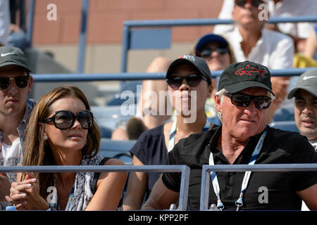 FLUSHING NY- SEPTEMBER 02:  Pro golfer Greg Norman and his wife Kirsten Kutner, Day nine of the 2014 US Open at the USTA Billie Jean King National Tennis Center on September 2, 2014 in the Flushing neighborhood of the Queens borough of New York City   People:  Greg Norman, Kirsten Kutner Stock Photo