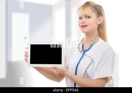 Young cheerful woman doctor is showing her blank tablet Stock Photo